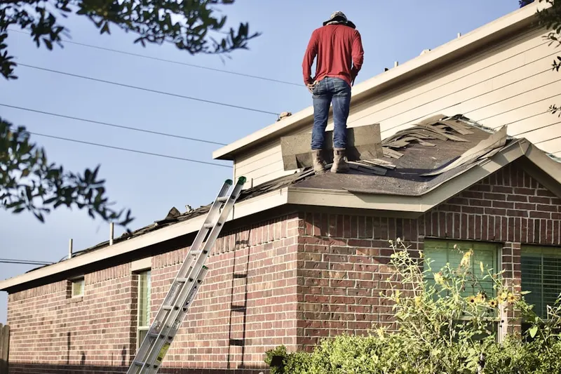 Professional roofer working on a residential roof in Woodland Lakes Preserve